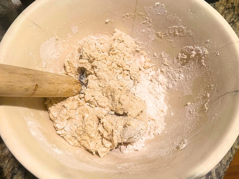 in process image of easy homemade pizza dough being combined with a dough hook
